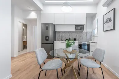 a kitchen and dining room with a glass table and chairs at Phaedrus Living Prosperity Residences Harmony in Athens