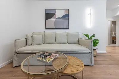 a living room with a couch and a glass table at Phaedrus Living Prosperity Residences Harmony in Athens