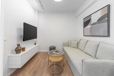 a living room with a couch and a tv at Phaedrus Living Prosperity Residences Harmony in Athens