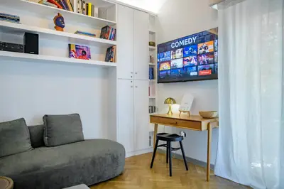 a living room with a couch and a desk at Luxurious & Stylish Kolonaki Haven in Athens