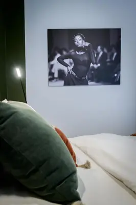 a black and white photo of a woman on a bed at Luxurious & Stylish Kolonaki Haven in Athens