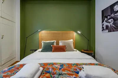 a bedroom with a large bed with green walls at Luxurious & Stylish Kolonaki Haven in Athens