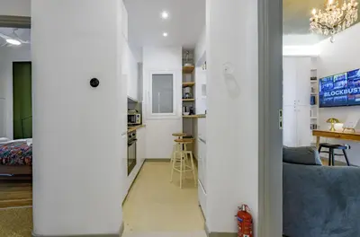 a living room and kitchen with white walls at Luxurious & Stylish Kolonaki Haven in Athens