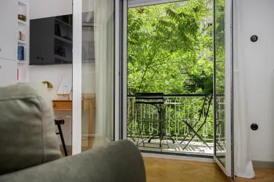a living room with a door open to a balcony at Luxurious & Stylish Kolonaki Haven in Athens