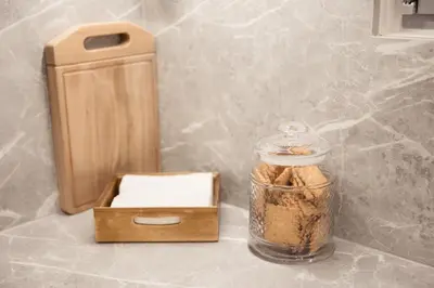 a counter top with a jar of food and a box at J&B Apartment in Athens