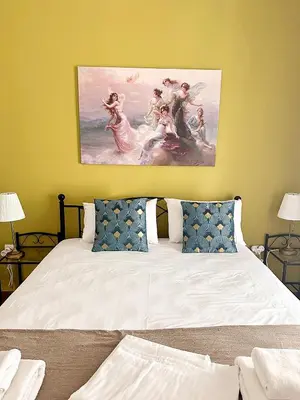 a bedroom with a bed with a painting on the wall at Check Point - Acropolis Retro in Athens