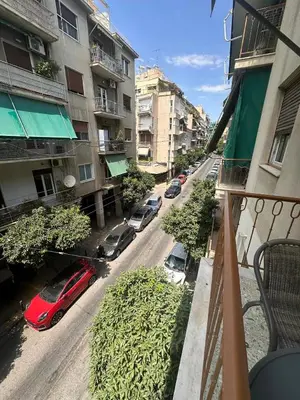 a view from a balcony of a street with cars parked at Check Point - Acropolis Retro in Athens