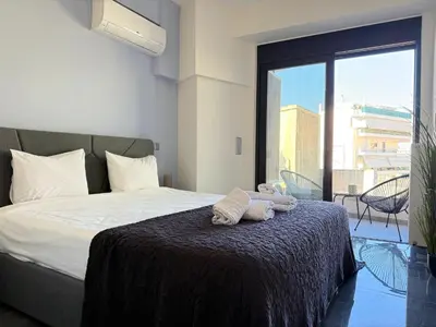 a bedroom with a bed with two towels on it at Sky Suite Apartments - Cloud9 in the City in Athens