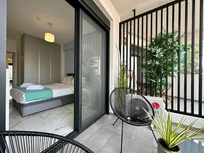 a balcony with a bed and chairs on a balcony at Sky Suite Apartments - Cloud9 in the City in Athens
