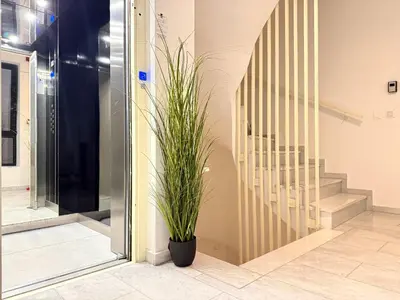 a plant in a pot next to a staircase at Sky Suite Apartments - Cloud9 in the City in Athens