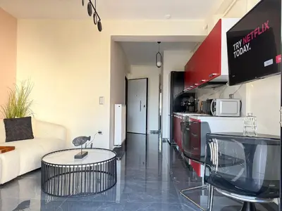 a kitchen and living room with a couch and a table at Sky Suite Apartments - Cloud9 in the City in Athens