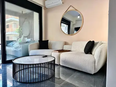 a living room with a couch and a round mirror at Sky Suite Apartments - Cloud9 in the City in Athens