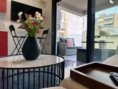 a vase with flowers sitting on a table in a room at Sky Suite Apartments - Cloud9 in the City in Athens