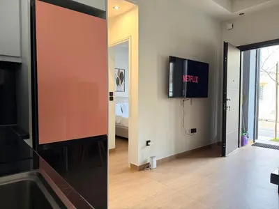 a living room with a flat screen tv on a wall at K43 Brand-New Stylish - Cloud9 in the city in Athens