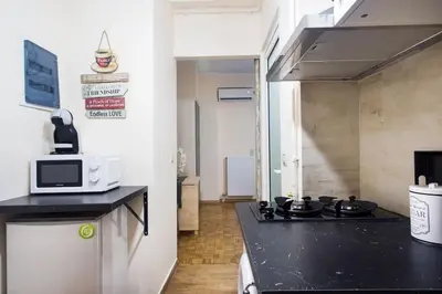 a small kitchen with a stove and a microwave at A pleasant stay near to Acropoli 1A in Athens
