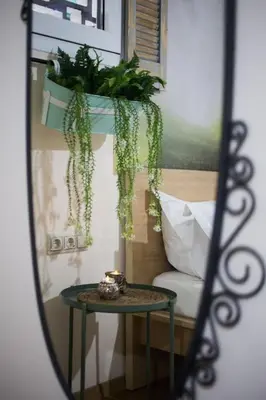 a mirror reflection of a table and a couch at A pleasant stay near to Acropoli 1A in Athens