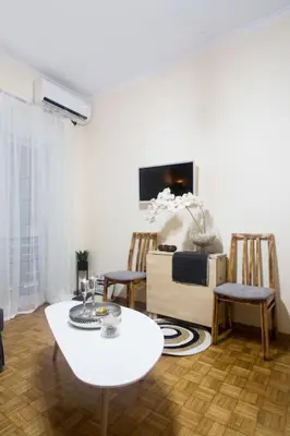 a living room with a white table and chairs at A pleasant stay near to Acropoli 1B in Athens