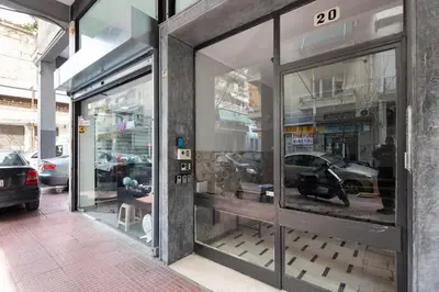 a store front with a window with cars in it at Pleasant Apartment Near To Acropolis in Athens