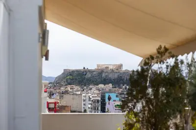 a view of a city from a balcony of a building at Pleasant Apartment Near To Acropolis in Athens