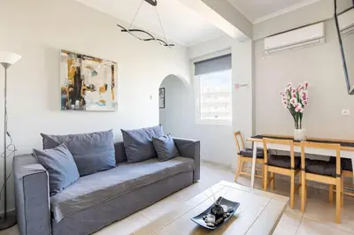 a living room with a couch and a table at Pleasant Apartment Near To Acropolis in Athens