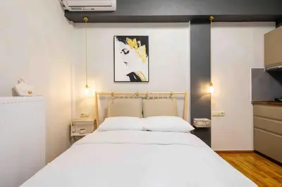 a bedroom with a large white bed in a room at Elegant studio next to Acropolis 2 in Athens