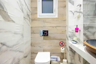 a bathroom with a toilet and a sink at Elegant studio next to Acropolis 2 in Athens