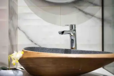 a wooden sink with a faucet in a bathroom at Elegant studio next to Acropolis 2 in Athens