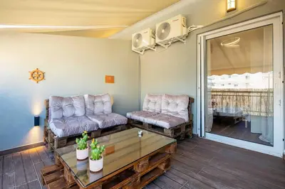 a living room with two couches and a coffee table at Holiday close to Acropolis 1 in Athens