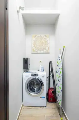 a washer and dryer in a white laundry room at Holiday close to Acropolis 1 in Athens