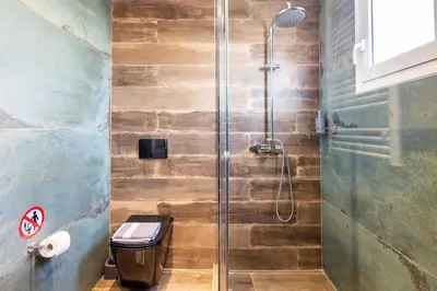 a shower stall with a toilet in a bathroom at Holiday close to Acropolis 1 in Athens