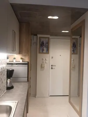 a kitchen with a white refrigerator and a door at Lux Studio in Ilioupoli, 20 min from Acropolis in Athens