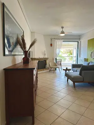 a living room with a couch and a table at Saronida365 Sea & Sunset view in Saronida