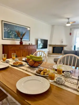 a table with plates of food and a bowl of bananas at Saronida365 Sea & Sunset view in Saronida