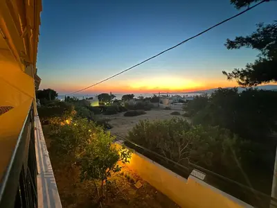 a view of a sunset from the balcony of a house at Saronida365 Sea & Sunset view in Saronida