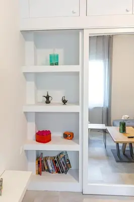 a white book shelf in a living room at Memory in Athens