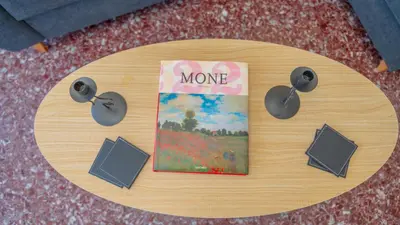 a round wooden table with speakers and a book at Amazing View Of Acropolis in Athens