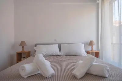 a bedroom with a bed with white towels on it at Amazing View Of Acropolis in Athens