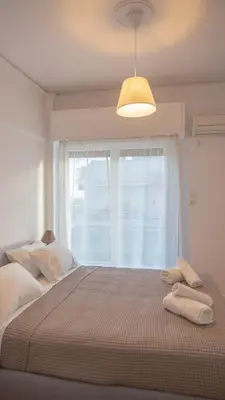 a bedroom with a large bed with a window at Amazing View Of Acropolis in Athens