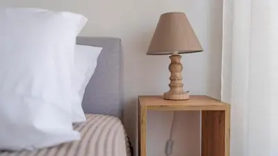 a lamp on a night stand next to a bed at Amazing View Of Acropolis in Athens