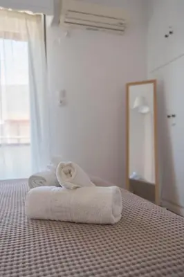 a bedroom with two towels on a bed at Amazing View Of Acropolis in Athens