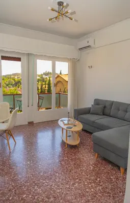 a living room with a couch and a table at Amazing View Of Acropolis in Athens