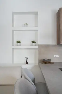 a living room with a couch and a chair at Plaka House - Boutique Apartments in Athens