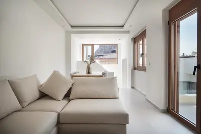 a living room with a couch and a table at Plaka House - Boutique Apartments in Athens