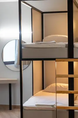 a room with bunk beds and a mirror at Athens Hawks Urban in Athens