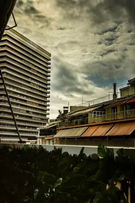 a view of a tall building with a cloudy sky at Urban apt Metro line 3 1min walk in Athens