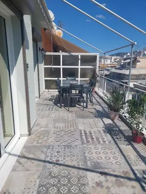a patio with a table and chairs on a balcony at The sunny terrace of Athens in Athens