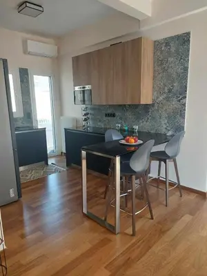 a kitchen with a table and chairs in a room at The sunny terrace of Athens in Athens