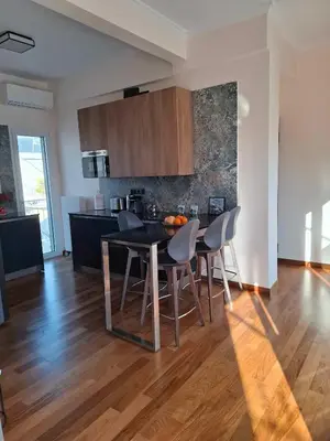 a kitchen with a table and chairs in a room at The sunny terrace of Athens in Athens