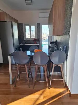 a kitchen with three chairs and a table in a kitchen at The sunny terrace of Athens in Athens