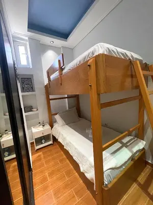 a room with two bunk beds in a house at Medusa Apartment in Artemida